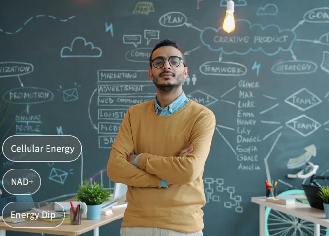 Man standing in front of a chalkboard with business strategy mind map focusing on cellular energy and NAD+