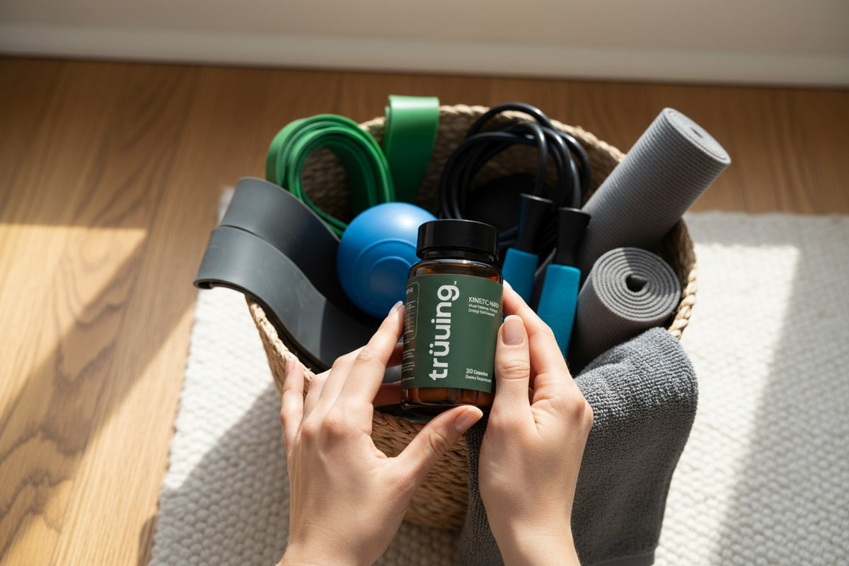 Person holding a bottle of 'truuing' supplements with fitness equipment in the background